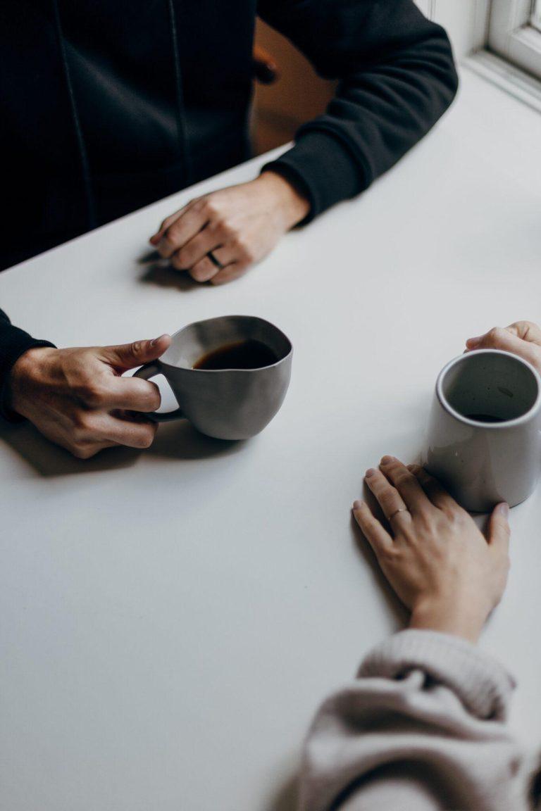 Two people drinking coffee